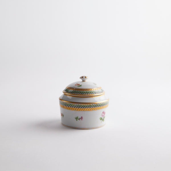 White bowl with multicoloured lid with floral and gold design.