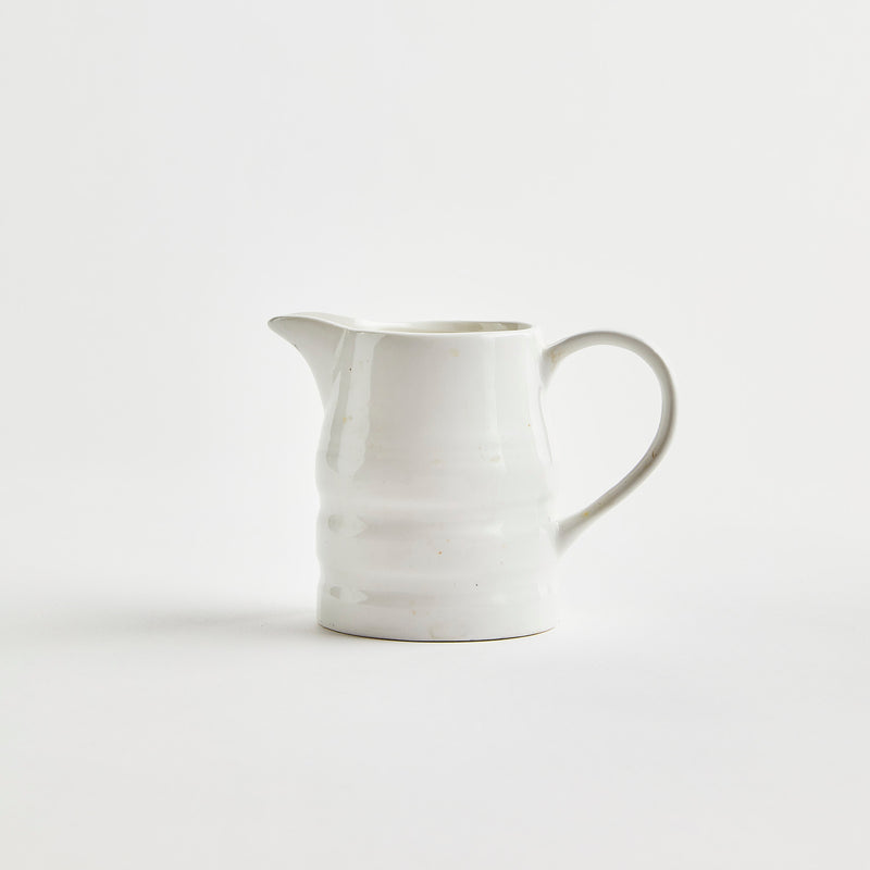 White ceramic jug with ribbed design.