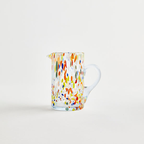 Glass jug with multicolour design.