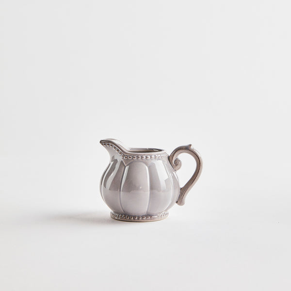 Grey ceramic jug with embossed design.