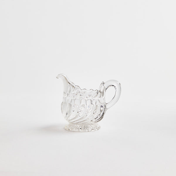 Clear glass jug with large ripple design.