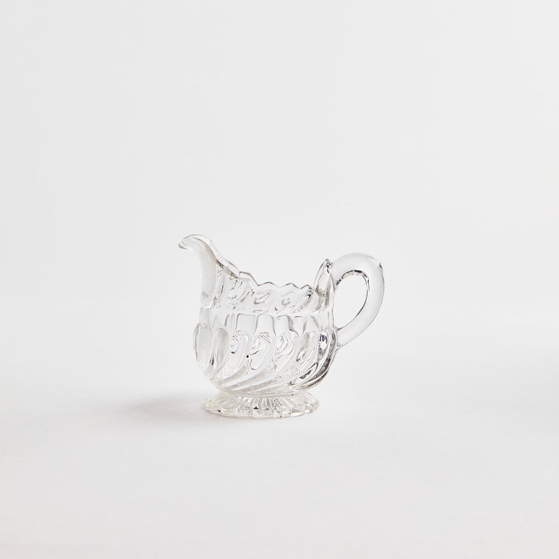 Clear glass jug with large ripple design.