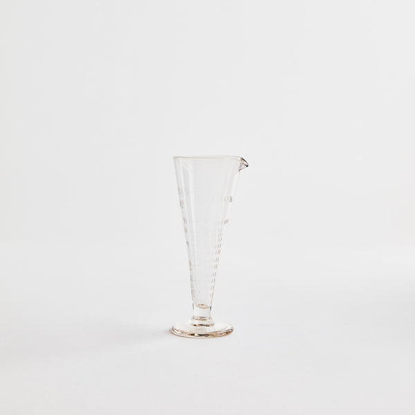 Tall clear glass jug.