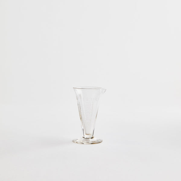 Tall clear glass jug.