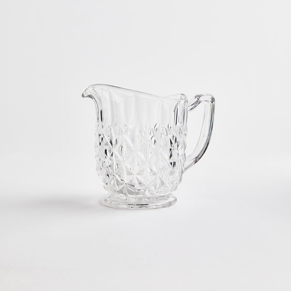 Clear glass jug with diamond embossed design.