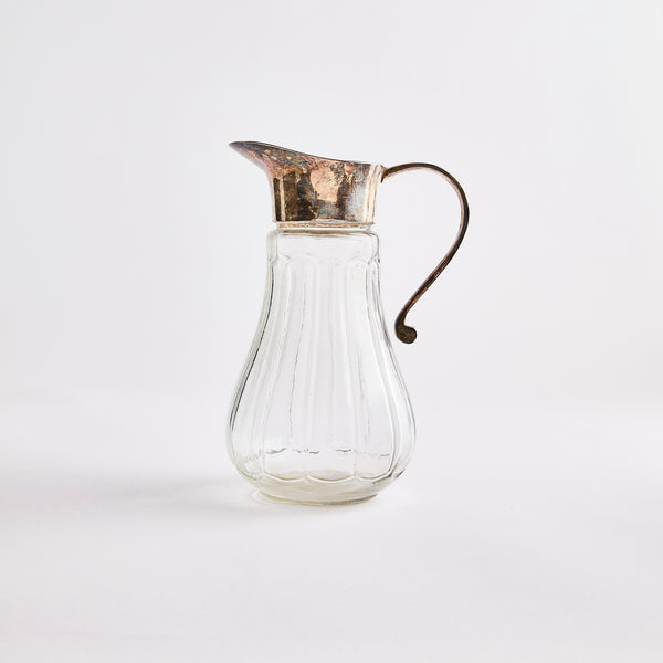 Clear glass jug with diamond embossed design with light silver top.