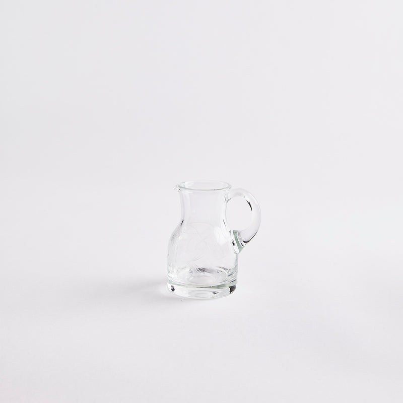 Clear glass hug with etched design.