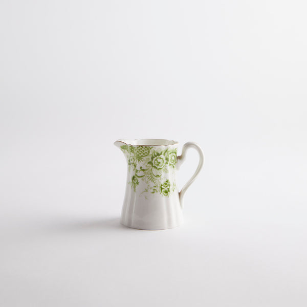 White jug with green floral detailing.