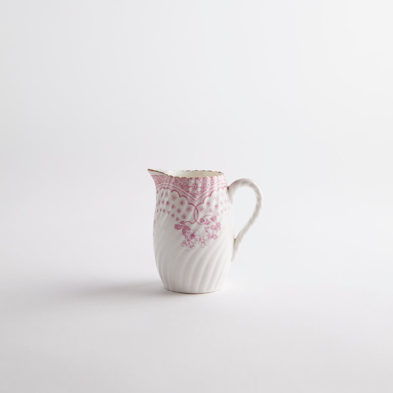 White jug with pink floral detailing.