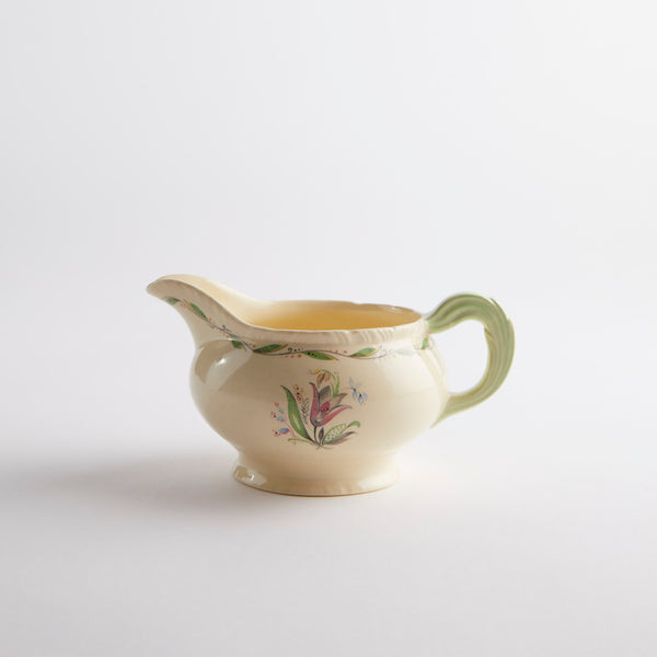 Cream jug with green floral detailing.