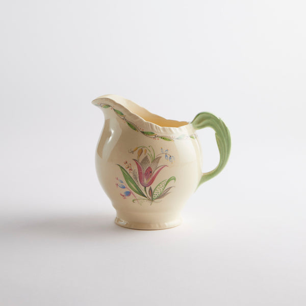 Cream jug with green floral detailing.