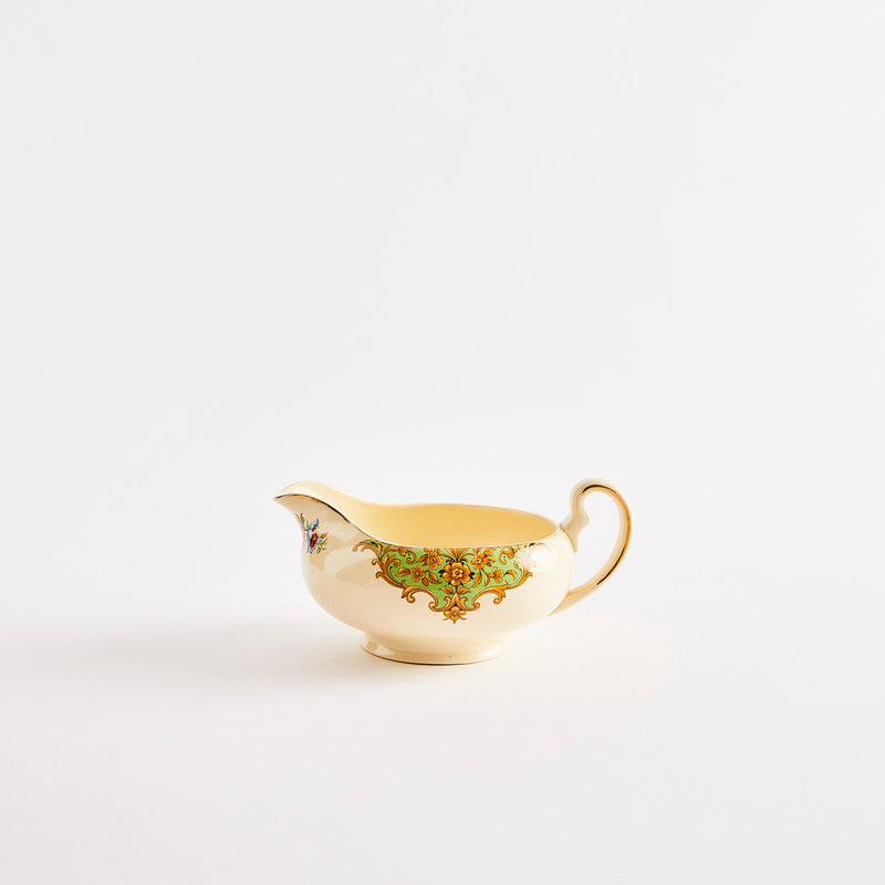 Cream jug with floral detailing.