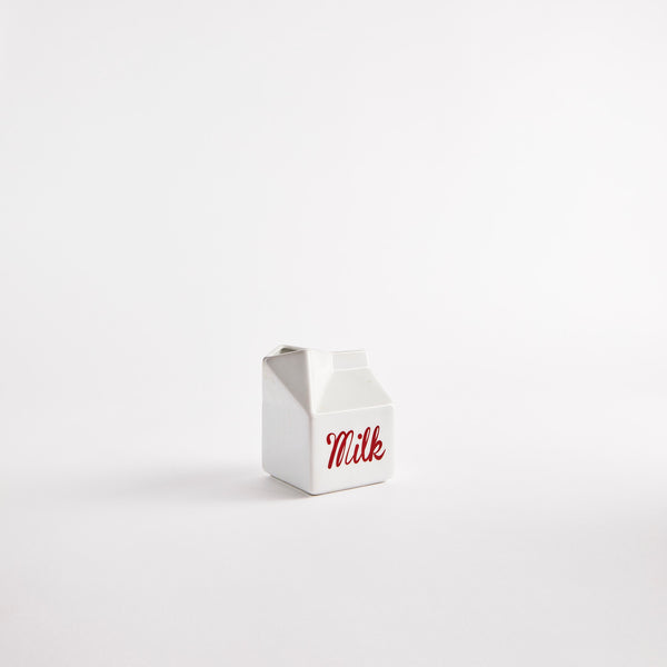 White jug with 'Milk' in red text.