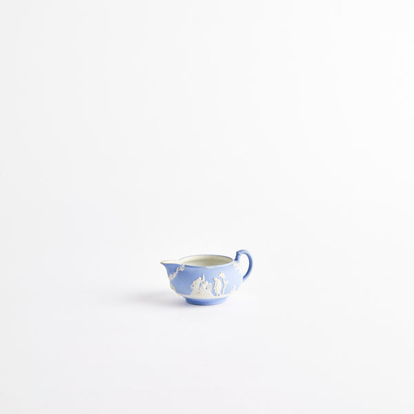 Blue ceramic jug with embossed detailing.