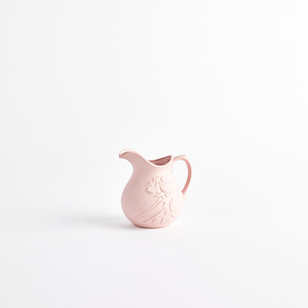 Pink ceramic jug with embossed detailing.