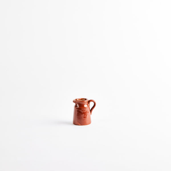 Brown ceramic jug.