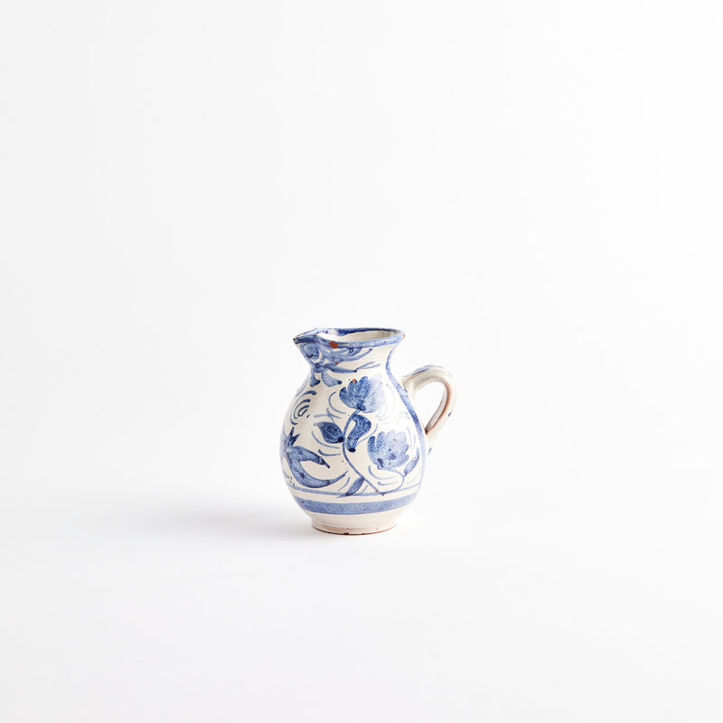 White ceramic jug with blue floral design.