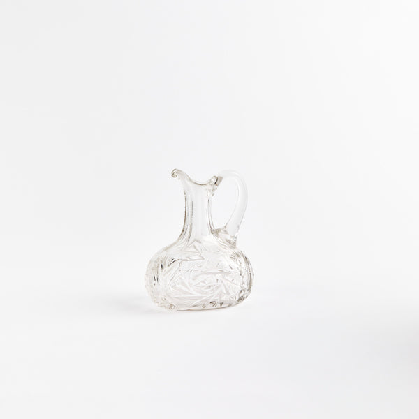 Clear glass jug with etched design.