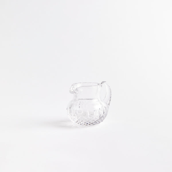 Clear glass jug with etched design.