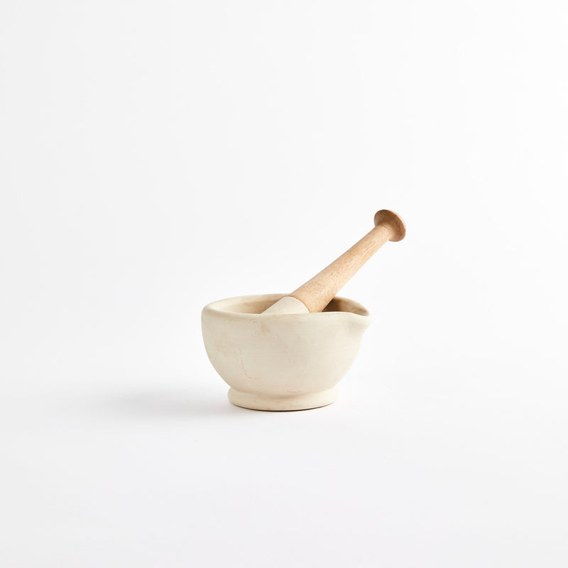 Beige pestle and mortar.