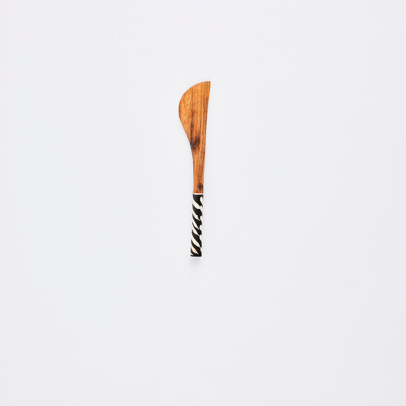 Wooden spoon with zebra print handle.