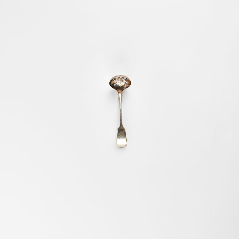Silver slotted ladle.