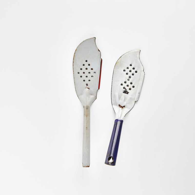 Two enamel slotted fish slicers.