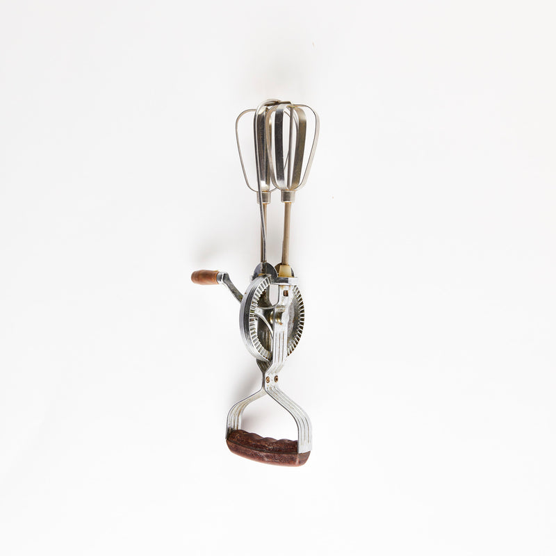 Silver whisk with wooden handles.