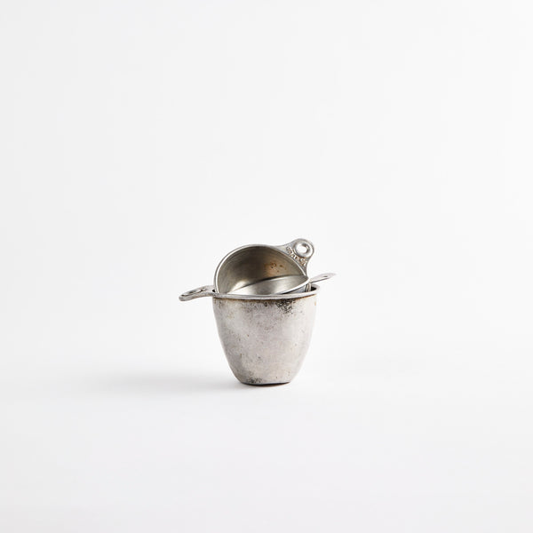 Silver vintage measuring cup.