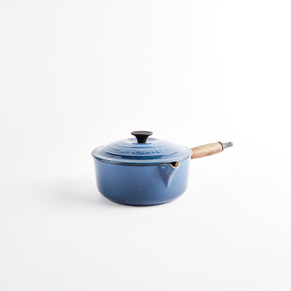 Le Creuset Pan with lid and wooden handle.