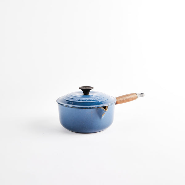 Le Creuset Pan with lid and wooden handle.