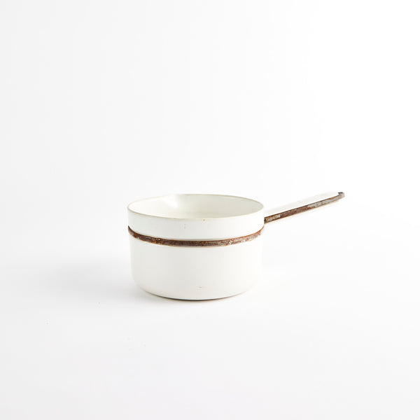 White enamel pan with handle.