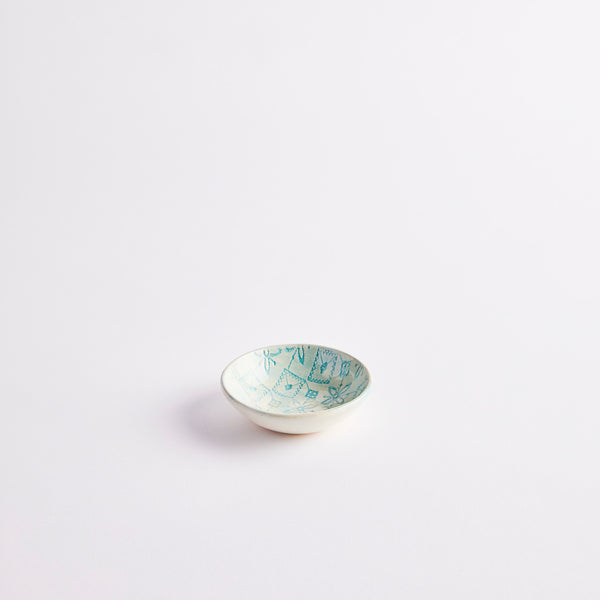 Blue ceramic pinch pot with embossed design.