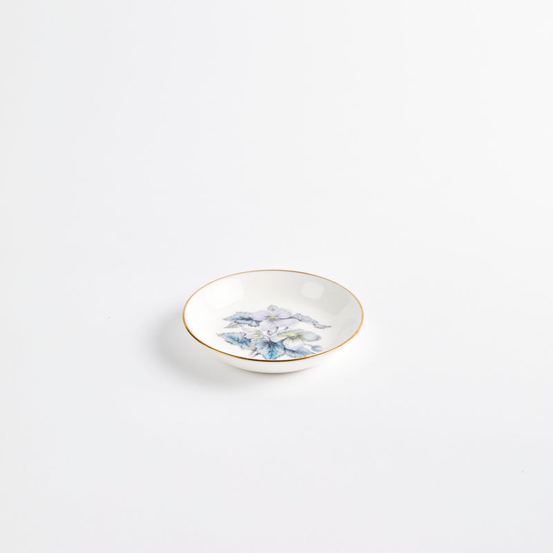 Mini white floral design plate with gold rim.