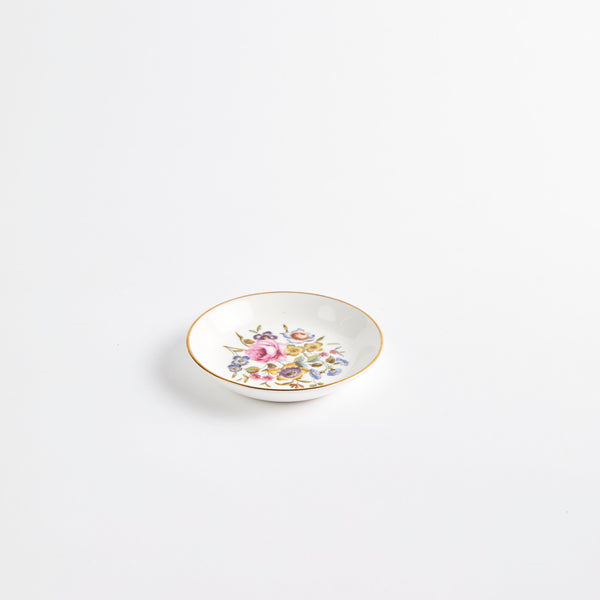 Mini white floral design plate with gold rim.