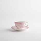 Pink and white tea cup with saucer.