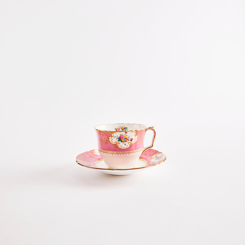 Pink and white tea cup with saucer.