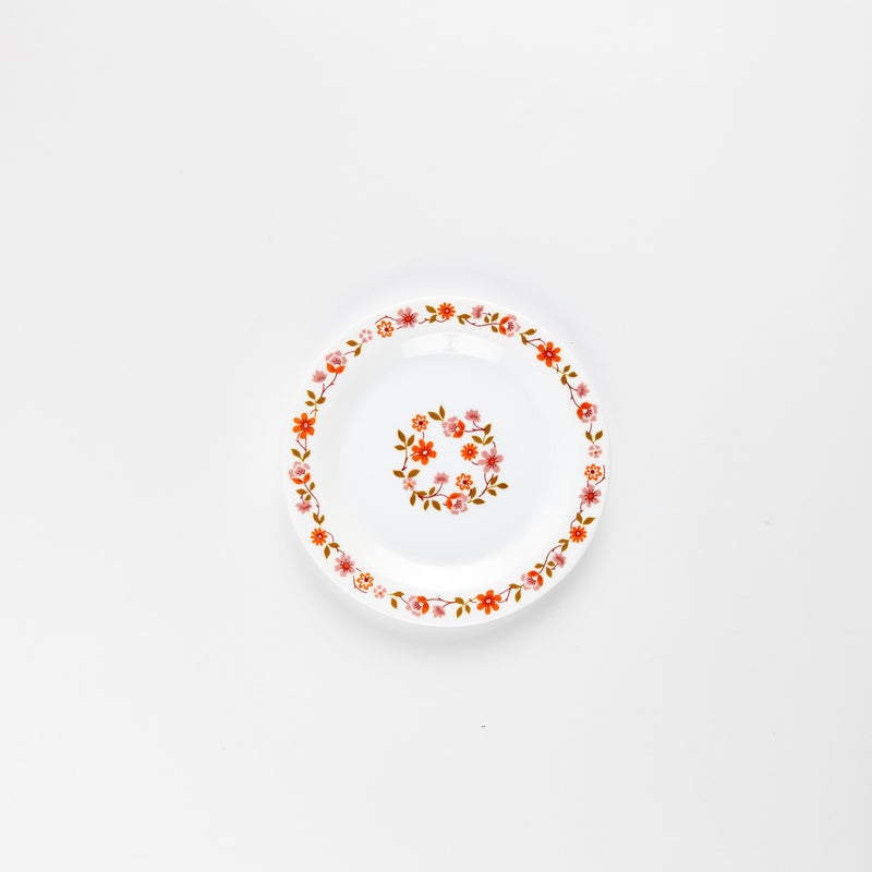 White plate with pink and orange flowers design.