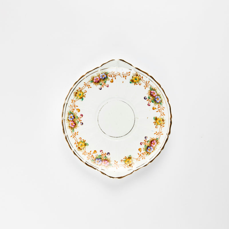 White plate with multicolour flower detail and gold rim.