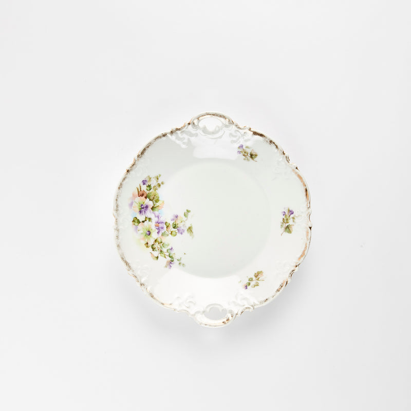 White plate with gold and multicolour floral detail.