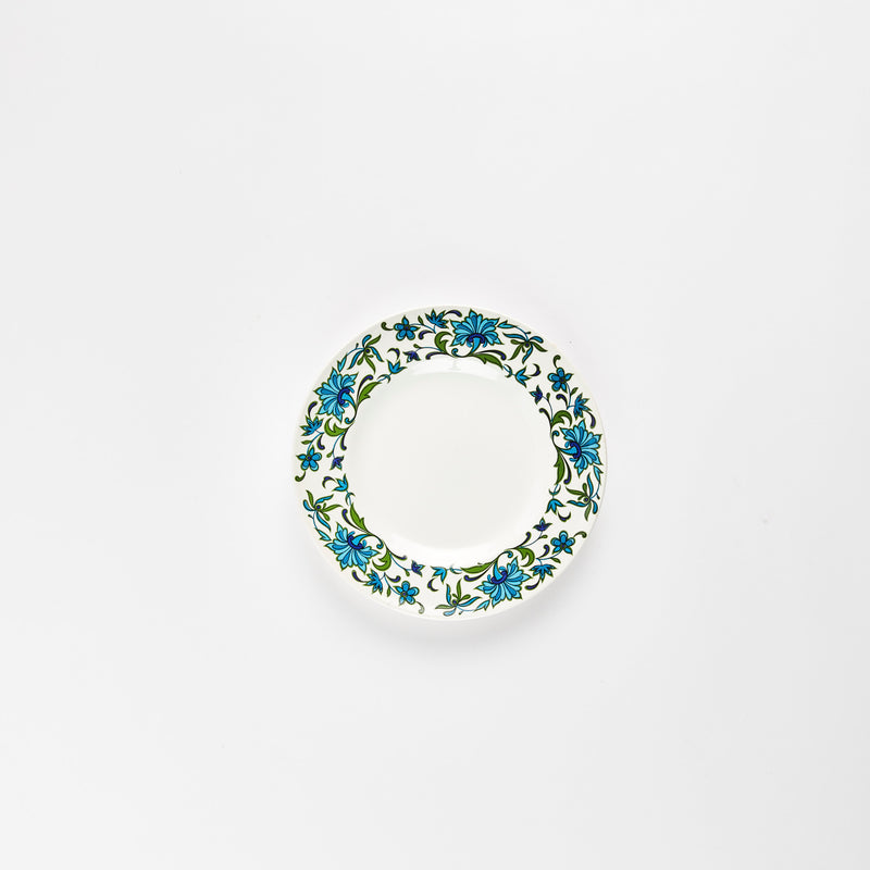 White plate with blue and green floral detail rim.