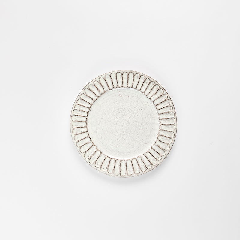 Beige ceramic plate with grey embossed detail.