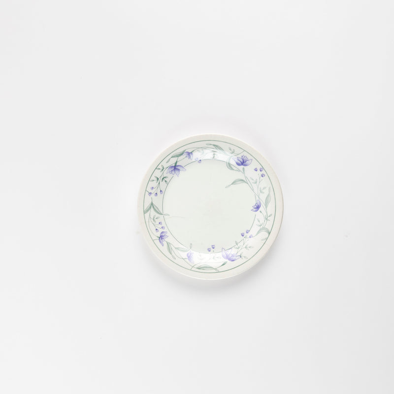 White plate with purple and green floral design.