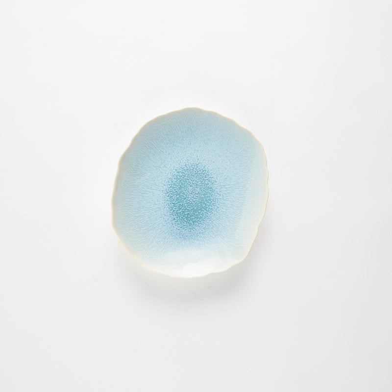 Blue glazed plate with wavy edges.