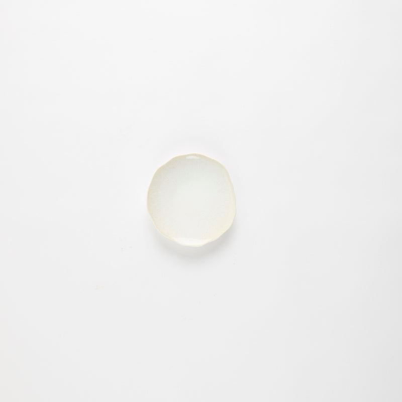 Cream plate with wavy edges.