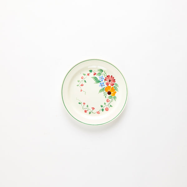 Cream with multicoloured floral design and green rim plate.