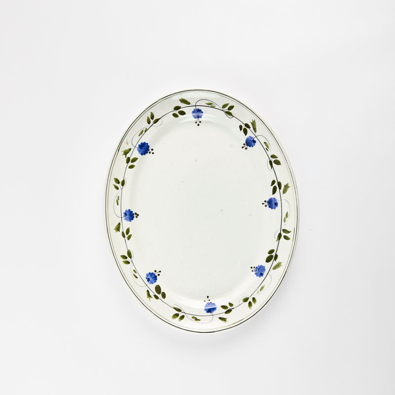 White with green leaf and blue flower rim detail platter.