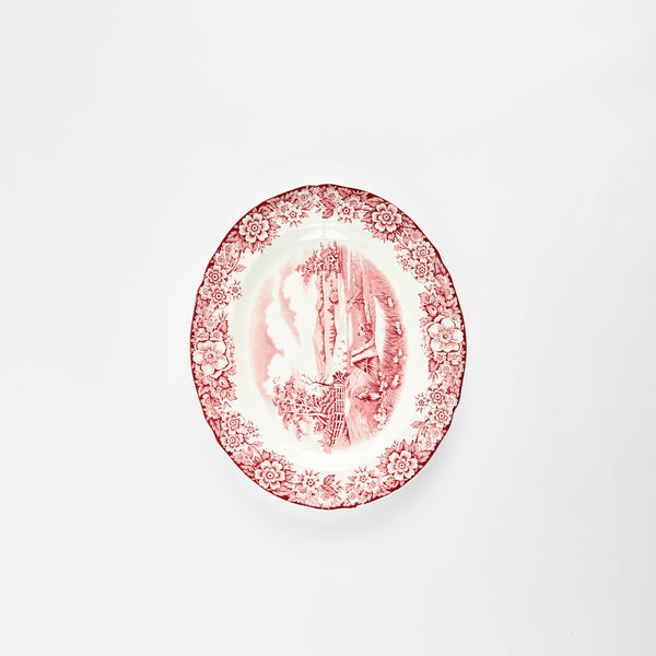 White platter with traditional red floral and farm detail design.