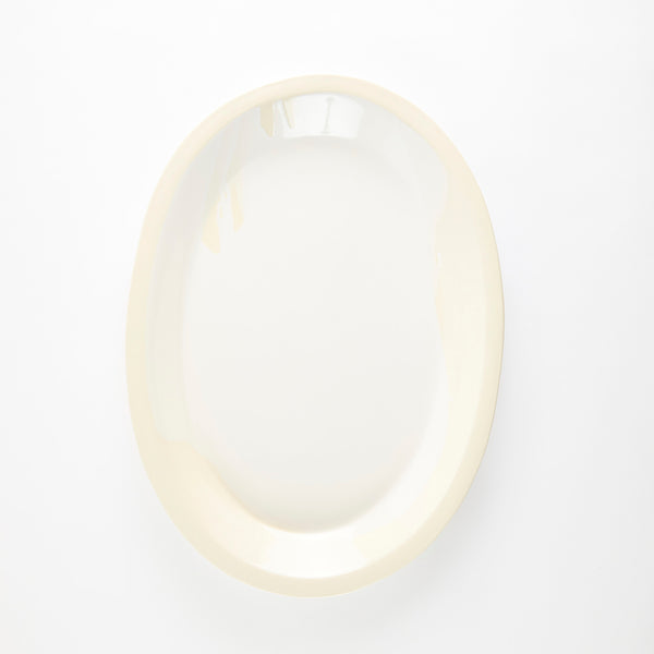 White oval ceramic platter with cream rim.
