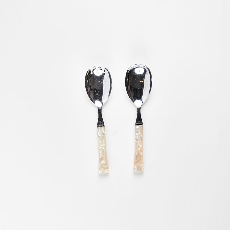 Silver salad servers with pearl handles.